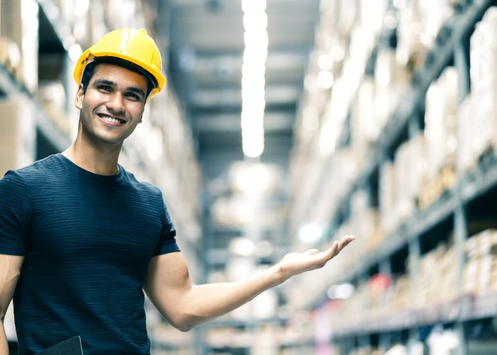 smart indian engineer man wearing safety helmet doing stock tick